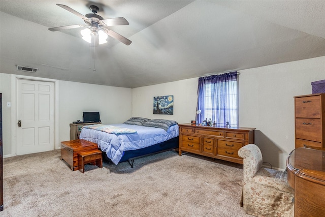 bedroom with vaulted ceiling, light carpet, a textured ceiling, and ceiling fan