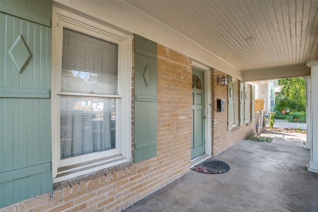 view of exterior entry with covered porch