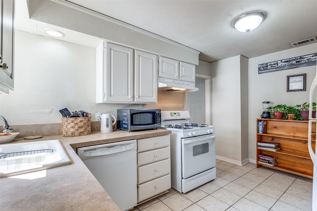 kitchen featuring sink, white appliances, white cabinets, and light tile patterned flooring