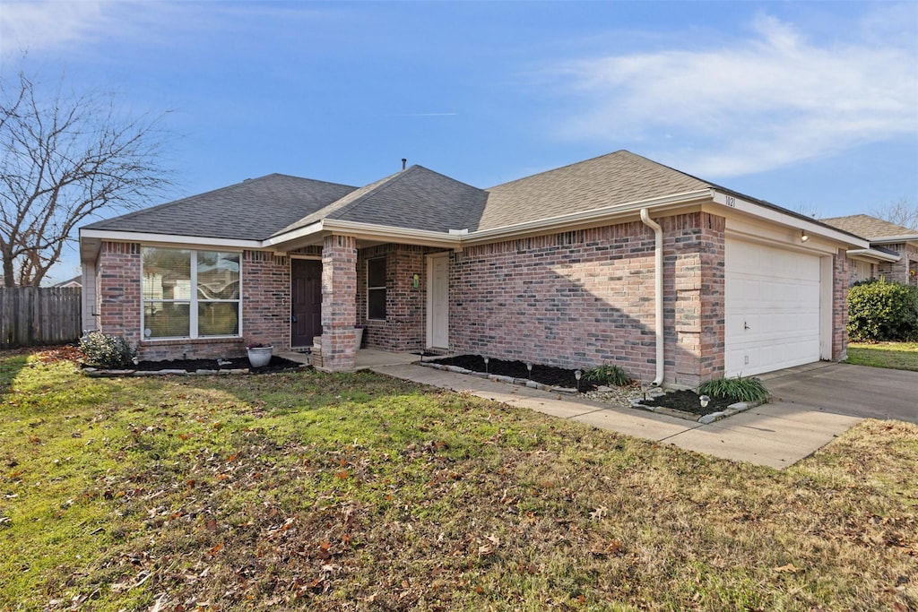 ranch-style home with a front yard and a garage