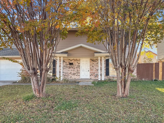 view of front of property featuring a garage and a front yard