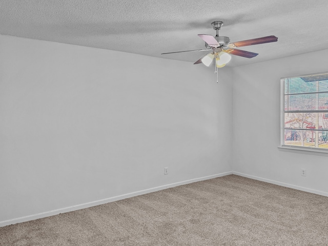 unfurnished room featuring a textured ceiling, ceiling fan, and carpet