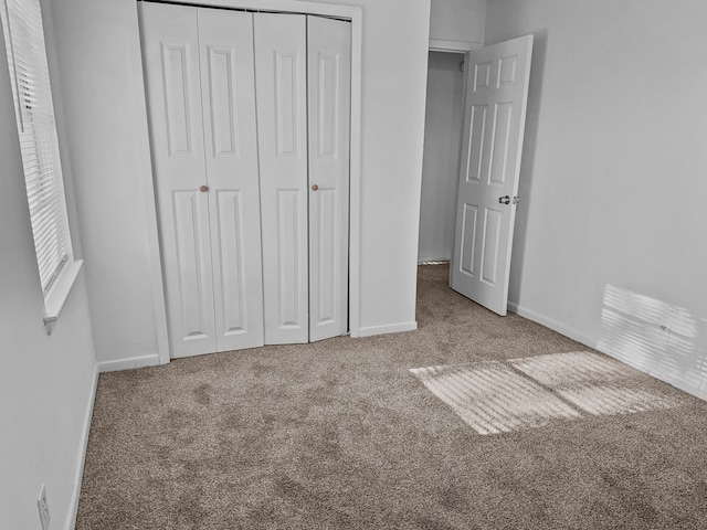 unfurnished bedroom featuring a closet and carpet floors