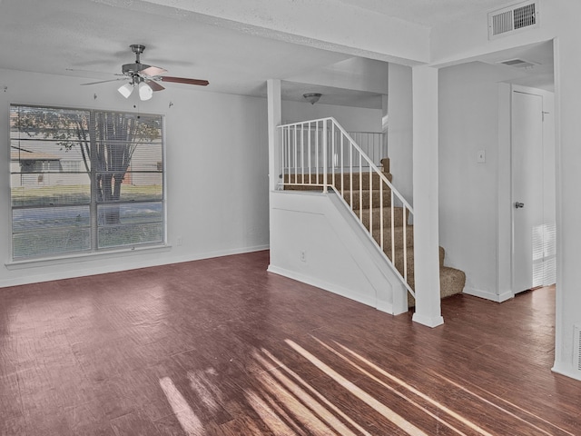 unfurnished living room with a textured ceiling and ceiling fan