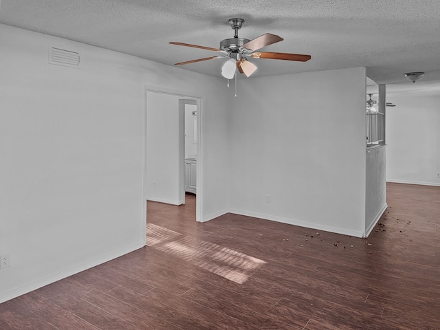 empty room with a textured ceiling and ceiling fan