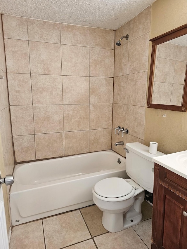 full bathroom with toilet, a textured ceiling, tile patterned flooring, tiled shower / bath, and vanity