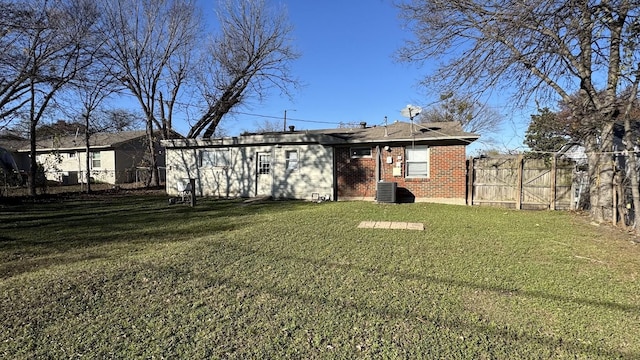 rear view of property featuring a lawn