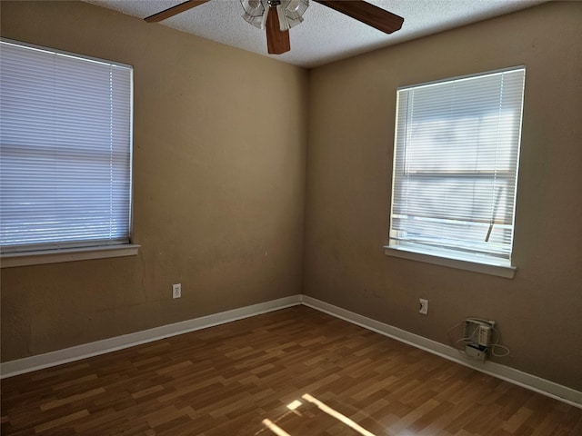 unfurnished room with dark wood-type flooring