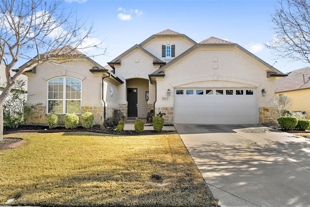 mediterranean / spanish house with a front lawn and a garage