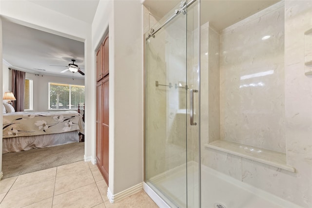 bathroom featuring a shower with door, ceiling fan, and tile patterned floors