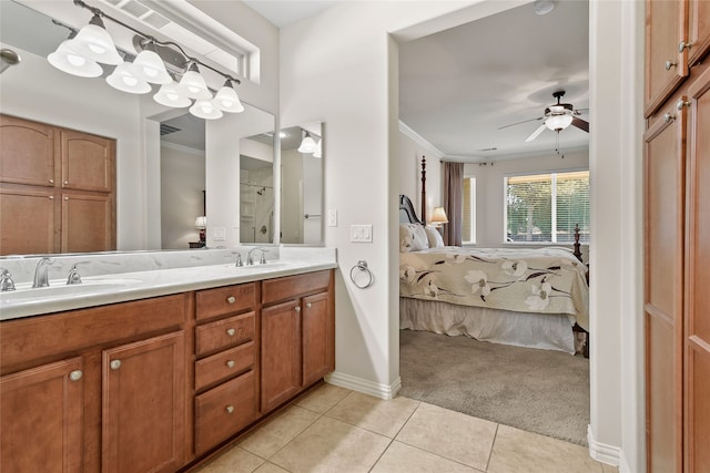 bathroom featuring ceiling fan, crown molding, vanity, and tile patterned floors