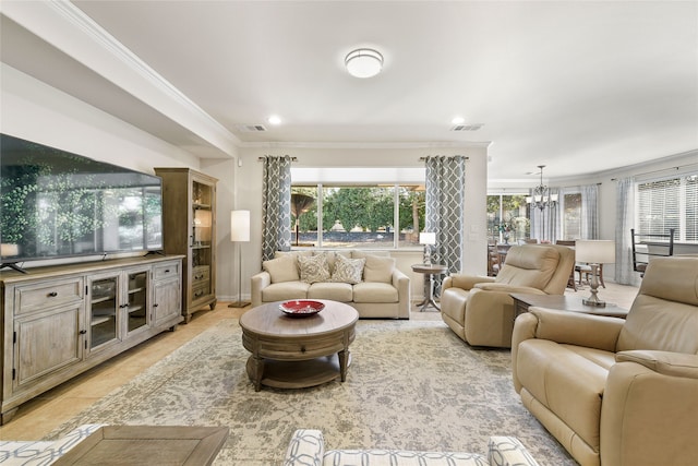 tiled living room featuring an inviting chandelier and crown molding