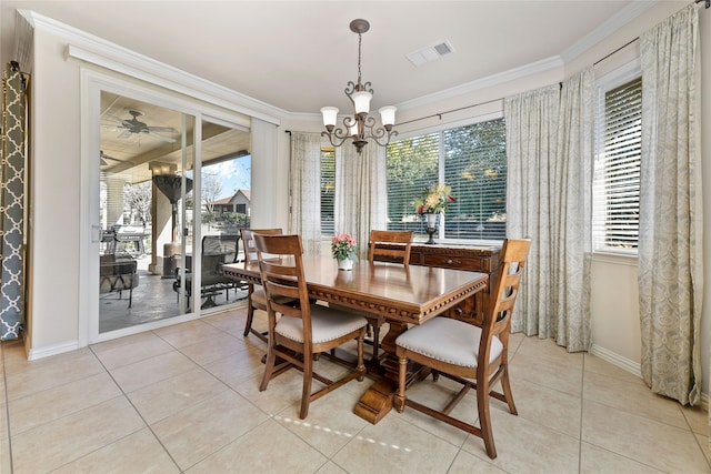 dining area featuring ornamental molding and light tile patterned floors