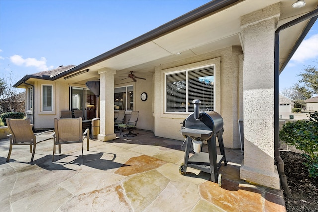 view of patio featuring ceiling fan and a grill