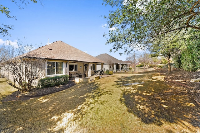 exterior space featuring a front lawn and a patio area