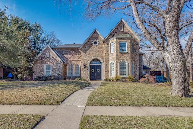 tudor house featuring a front yard