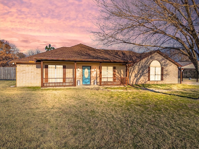 ranch-style home with a lawn