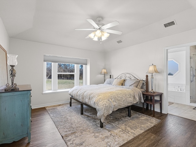 bedroom with dark hardwood / wood-style floors, connected bathroom, and ceiling fan