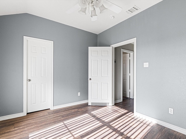 unfurnished bedroom with ceiling fan, dark hardwood / wood-style floors, and vaulted ceiling