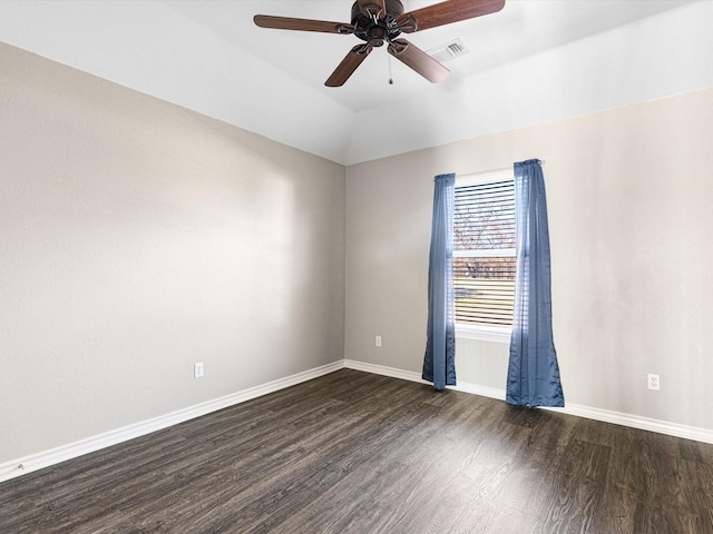 unfurnished room featuring vaulted ceiling, dark hardwood / wood-style floors, and ceiling fan