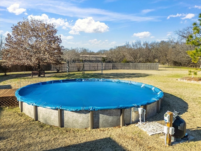 view of pool with a yard