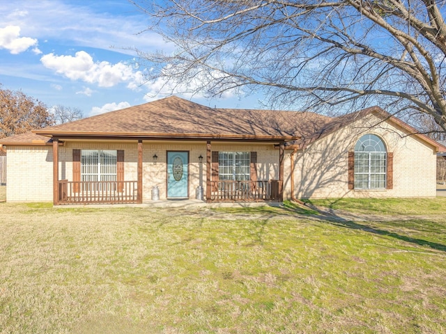 single story home with a front yard and covered porch