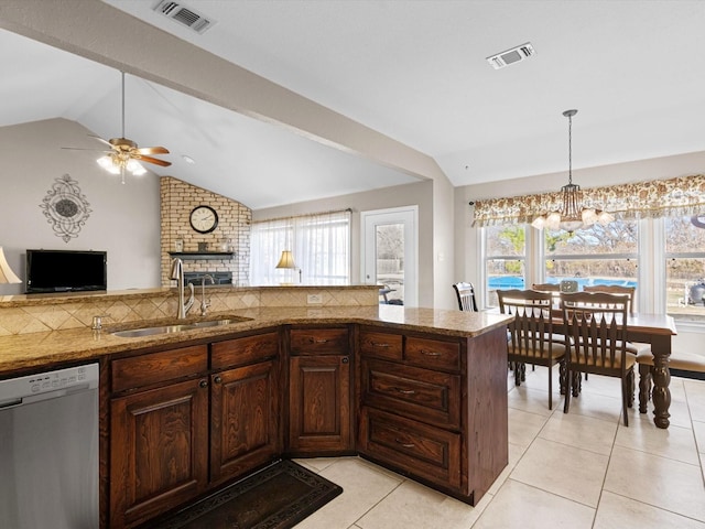 kitchen featuring sink, ceiling fan with notable chandelier, dishwasher, light tile patterned flooring, and decorative backsplash