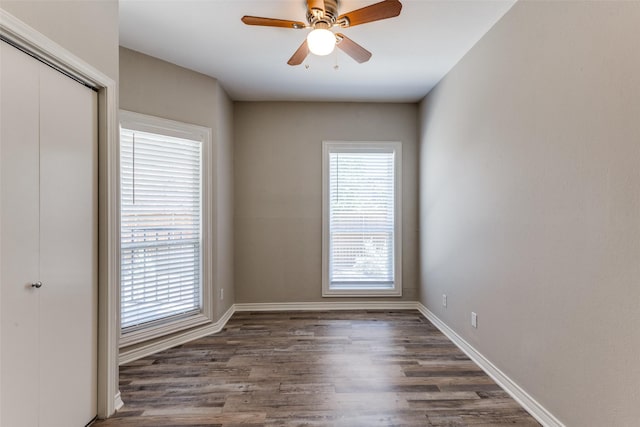 unfurnished room with dark wood-type flooring and ceiling fan