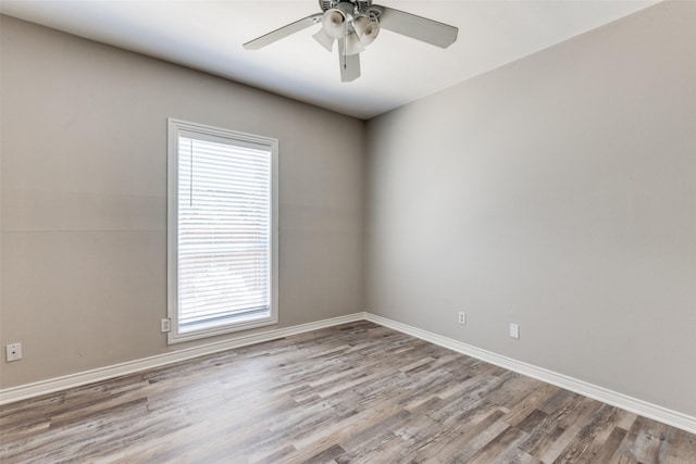 empty room featuring ceiling fan, light hardwood / wood-style flooring, and a wealth of natural light