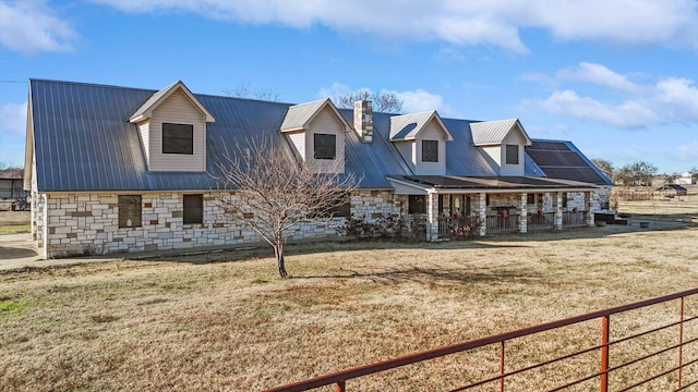 cape cod home with a front lawn