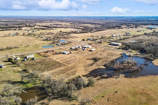 birds eye view of property with a rural view and a water view