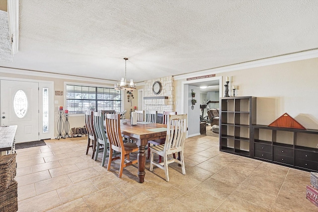 dining room featuring a textured ceiling, ornamental molding, and a chandelier