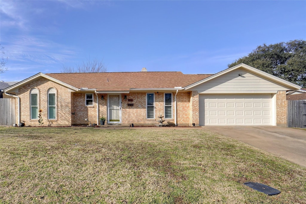 single story home with a garage and a front lawn