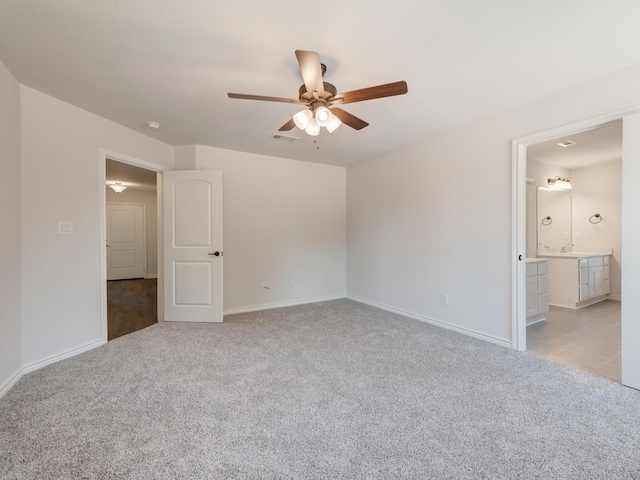 spare room with ceiling fan and light colored carpet