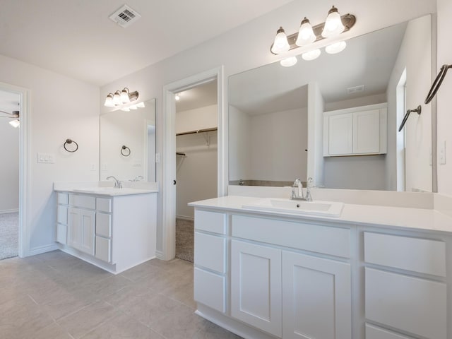 bathroom with ceiling fan, tile patterned floors, and vanity