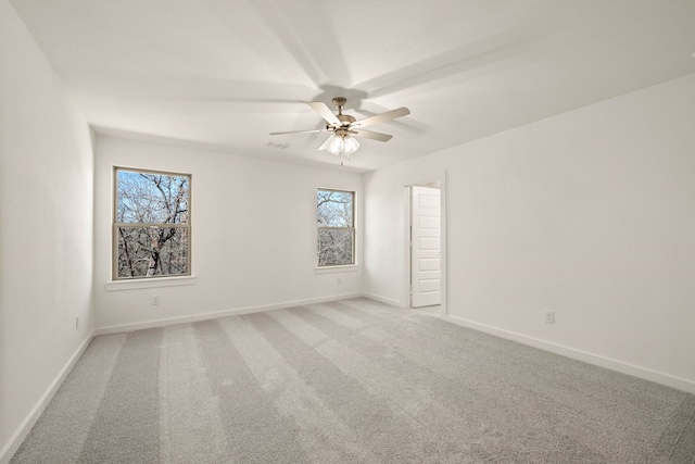 spare room featuring ceiling fan and carpet flooring