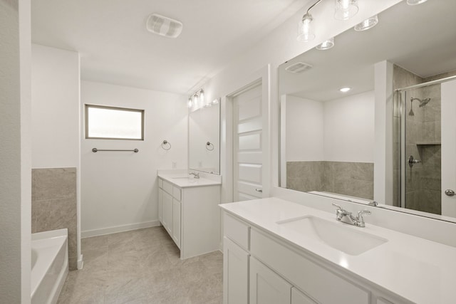 bathroom with vanity and separate shower and tub