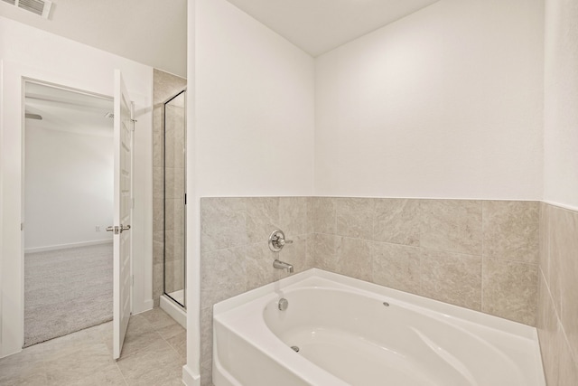 bathroom with tile patterned floors and plus walk in shower