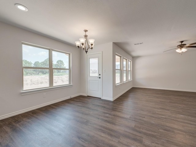 interior space with ceiling fan with notable chandelier and dark hardwood / wood-style floors