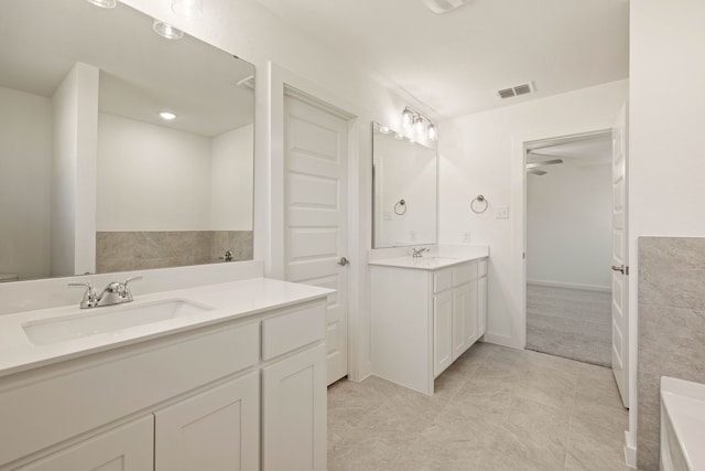 bathroom with vanity and a bath