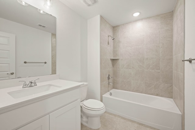 full bathroom featuring tiled shower / bath combo, vanity, tile patterned flooring, and toilet