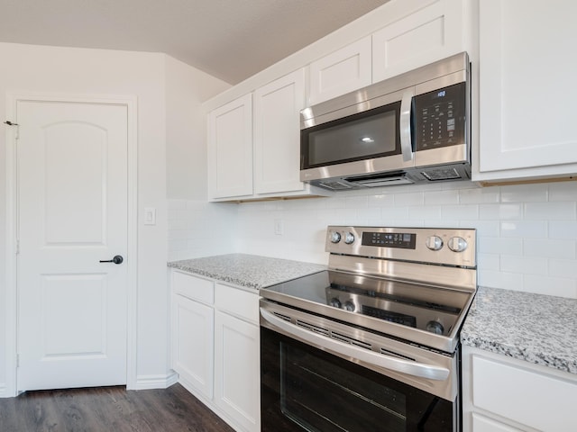 kitchen featuring white cabinets, stainless steel appliances, and dark hardwood / wood-style flooring