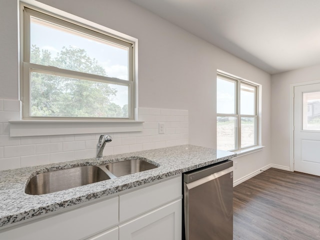 kitchen featuring sink, white cabinetry, dishwasher, tasteful backsplash, and light stone countertops