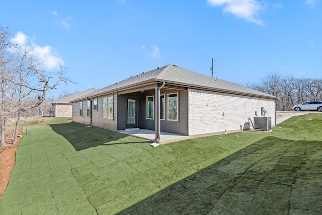 back of property with a yard, central AC, and a patio area