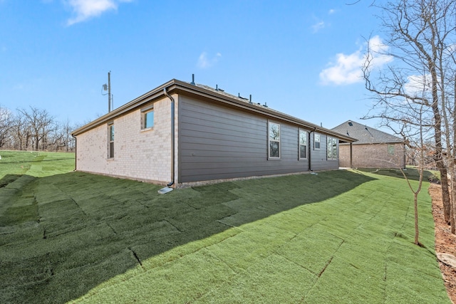 view of side of home with a lawn