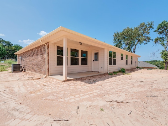 rear view of house featuring a patio and central AC