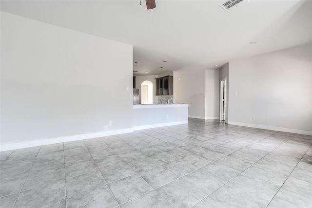 unfurnished living room featuring ceiling fan