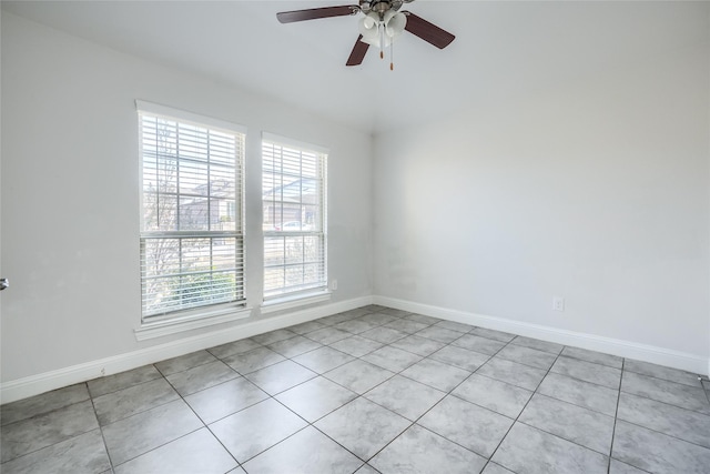 empty room featuring ceiling fan and light tile patterned floors