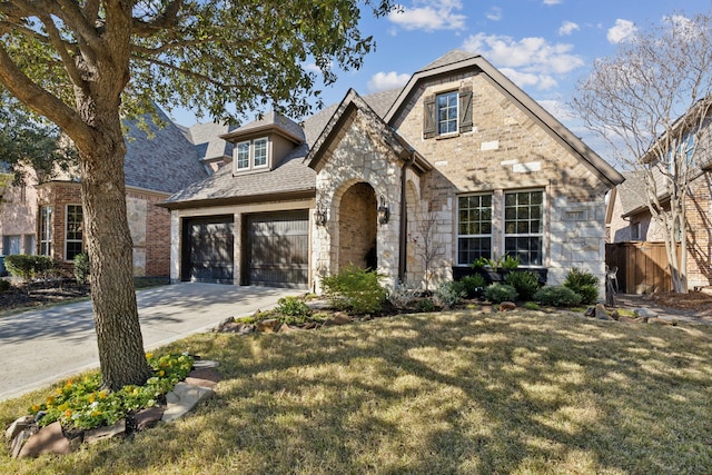 view of front of home featuring a front yard and a garage