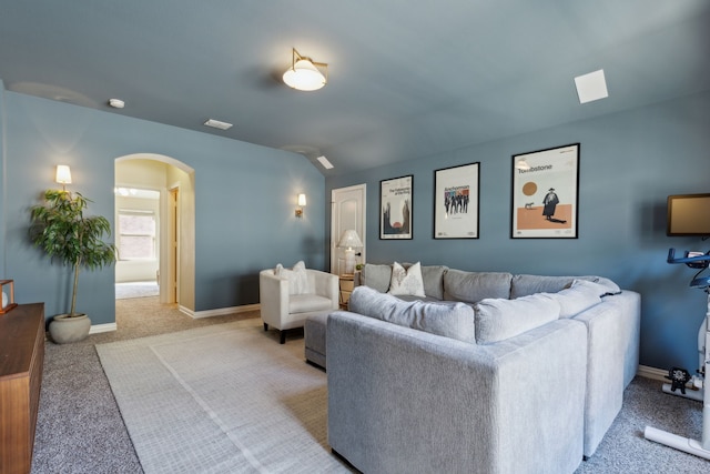 carpeted living room featuring vaulted ceiling